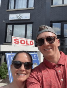 A couple in front of their sold property