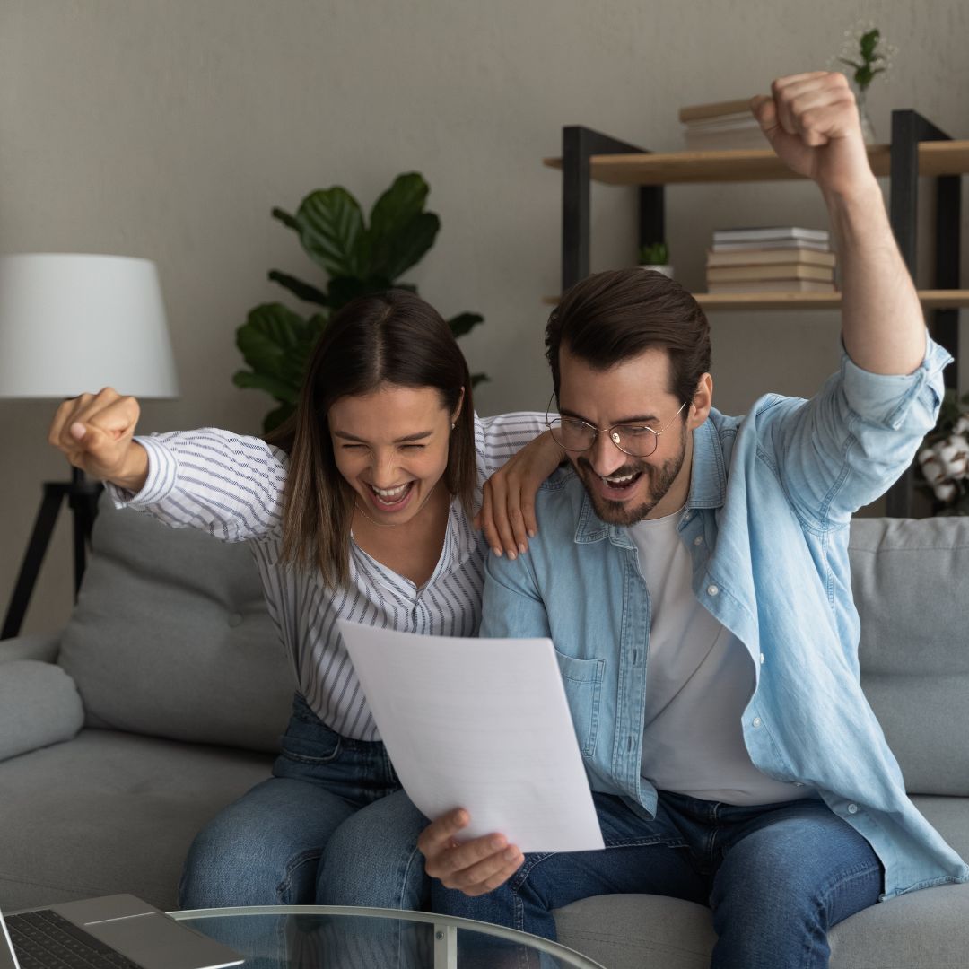 couple cheering with good news