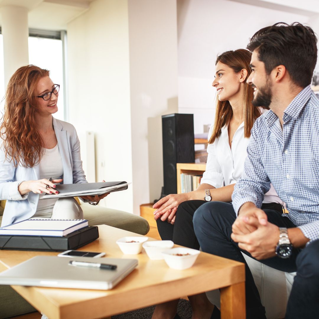 a couple speaking with a real estate expert