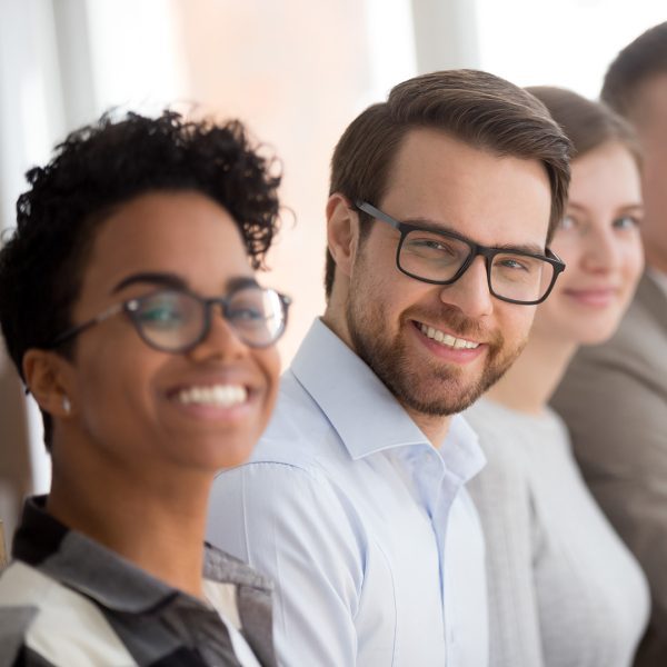 A group of investors sitting at a conference and smiling